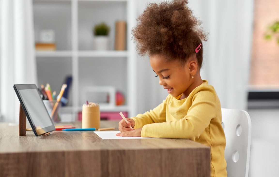 Little Girl Drawing with Pencils at Home